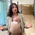 Swedish Environment Minister Romina Pourmokhtari, carrying her baby Adam, speaks to journalists before a meeting of EU environment and climate ministers, in Luxembourg